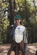 t-shirt-mockup-of-a-woman-wearing-a-dad-hat-in-the-woods-30463.png